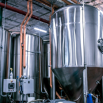Industrial distillery processing equipment illustrating a circular distillery model with integrated material and energy flows.