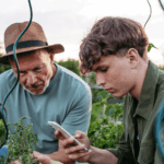 Researchers examining crops in an agricultural field as part of USDA AFRI competitive grants program research