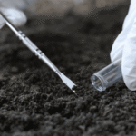 Scientist collecting and preparing biochar or soil samples for laboratory testing and carbon measurement verification